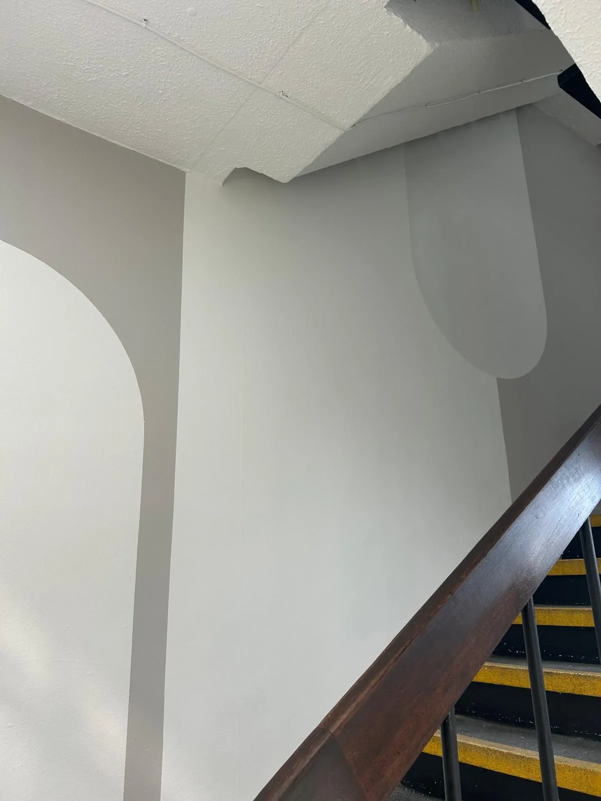Close view of curved grey and white colour blocks painted around a stairwell